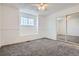 Bright bedroom featuring gray carpeting, white walls, base molding, and a large closet at 1737 Jules Ct, Highlands Ranch, CO 80126