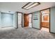 Spacious bedroom with grey carpet leading to bathroom and closet at 1737 Jules Ct, Highlands Ranch, CO 80126