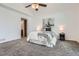 Bright bedroom features neutral colors, ceiling fan, and leads into en suite bathroom at 1737 Jules Ct, Highlands Ranch, CO 80126