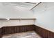 Walk-in closet features wood paneling and wooden rods for easy clothing storage at 1737 Jules Ct, Highlands Ranch, CO 80126