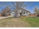 Charming home with manicured front lawn, lush landscaping, and a covered porch at 1737 Jules Ct, Highlands Ranch, CO 80126