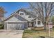 Charming home featuring a gray exterior, stone accents, a well-maintained yard, and a two-car garage at 1737 Jules Ct, Highlands Ranch, CO 80126