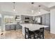 Bright kitchen with gray cabinetry, a spacious island, modern lighting, and stainless steel appliances at 1737 Jules Ct, Highlands Ranch, CO 80126