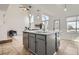 Spacious kitchen island featuring a sink, dishwasher, and storage, adjacent to the living area at 1737 Jules Ct, Highlands Ranch, CO 80126