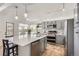 Modern kitchen with gray cabinets, stainless steel appliances, an island, and tile flooring at 1737 Jules Ct, Highlands Ranch, CO 80126