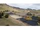 Stunning aerial view of estate property with a sprawling home, large garage, and beautiful mountain backdrop at 5881 Deer Meadow Trl, Golden, CO 80403