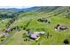 Breathtaking aerial view of home, garages, landscaping, and surrounding acreage at 5881 Deer Meadow Trl, Golden, CO 80403