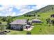 Aerial view highlighting the backyard's patio, deck, firepit and views of the surrounding property at 5881 Deer Meadow Trl, Golden, CO 80403