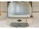 Closeup of the tub surrounded by marble and arched wall of decorative glass blocks at 5881 Deer Meadow Trl, Golden, CO 80403