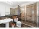 Modern bathroom featuring a glass shower with designer tile, contemporary vanity, and ample natural light at 5881 Deer Meadow Trl, Golden, CO 80403