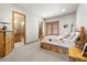 Cozy bedroom with rustic decor, wood accents, and an ensuite bathroom with glass shower at 5881 Deer Meadow Trl, Golden, CO 80403