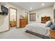 Comfortable bedroom with ensuite bathroom, natural light, and carpet flooring at 5881 Deer Meadow Trl, Golden, CO 80403