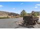 Scenic driveway with mountain views, complemented by vintage mining cart decor and lush landscaping at 5881 Deer Meadow Trl, Golden, CO 80403