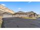 Sprawling ranch-style home with an attached garage and a circular driveway for easy access and ample parking at 5881 Deer Meadow Trl, Golden, CO 80403