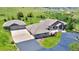 Aerial view of home showcases circular driveway, attached garages and beautiful landscaping at 5881 Deer Meadow Trl, Golden, CO 80403