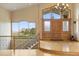 Grand foyer with a beautiful chandelier, hardwood floors, a staircase, and a large window offering picturesque views at 5881 Deer Meadow Trl, Golden, CO 80403