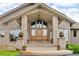 Stunning exterior entrance featuring a double door and large windows providing lots of natural light at 5881 Deer Meadow Trl, Golden, CO 80403