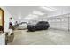 Spacious garage with high ceilings, multiple vehicles, and ample storage space, ideal for car enthusiasts at 5881 Deer Meadow Trl, Golden, CO 80403