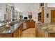 Open-concept kitchen with granite countertops, stainless steel appliances and breakfast bar at 5881 Deer Meadow Trl, Golden, CO 80403