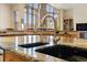 Gourmet kitchen island with granite countertops and dual sinks at 5881 Deer Meadow Trl, Golden, CO 80403