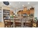 Spacious kitchen with custom wood cabinets, granite counters and breakfast bar seating at 5881 Deer Meadow Trl, Golden, CO 80403