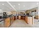 Expansive open kitchen features a curved counter with granite countertops and wood cabinets at 5881 Deer Meadow Trl, Golden, CO 80403