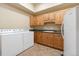 Bright laundry room featuring new washer/dryer and ample counter space with sink at 5881 Deer Meadow Trl, Golden, CO 80403