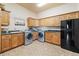 Functional laundry room with cabinetry, granite countertops, and modern washer/dryer units at 5881 Deer Meadow Trl, Golden, CO 80403