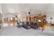 Open-concept living room featuring hardwood floors, large windows, and staircase to second floor at 5881 Deer Meadow Trl, Golden, CO 80403