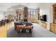 Inviting living room with a cozy fireplace, walls of windows and an adjacent eating nook at 5881 Deer Meadow Trl, Golden, CO 80403