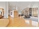 Expansive living room featuring hardwood floors, large windows, brick fireplace, and open floor plan at 5881 Deer Meadow Trl, Golden, CO 80403