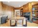 Office with custom wood paneling, built-in shelves, and fireplace at 5881 Deer Meadow Trl, Golden, CO 80403