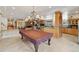 Large recreation room featuring a pool table, kitchen, and bar area with great lighting at 5881 Deer Meadow Trl, Golden, CO 80403