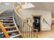 Elegant curved staircase featuring wrought iron railings and plush gray carpet runner, adding a touch of sophistication at 5881 Deer Meadow Trl, Golden, CO 80403