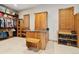 Custom closet with built-in shelving, cabinetry, and an island with granite countertop at 5881 Deer Meadow Trl, Golden, CO 80403