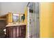 Bright bathroom featuring a white shower stall and wooden vanity with drawers at 10419 Christopher Dr, Conifer, CO 80433