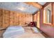 Charming bedroom features wood paneled walls, unique ceiling art, and ample natural light at 10419 Christopher Dr, Conifer, CO 80433