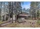Quaint cabin in a wooded setting with a garden and charming architectural details at 10419 Christopher Dr, Conifer, CO 80433