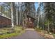 Stunning exterior view of a two-story home with natural wood siding and plenty of privacy at 10419 Christopher Dr, Conifer, CO 80433