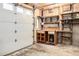 Functional garage with workbench and cabinets offering ample storage space for tools and projects at 10419 Christopher Dr, Conifer, CO 80433