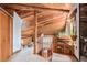 Hallway featuring wood beams, staircase, and built-in bookshelves, showcasing rustic charm at 10419 Christopher Dr, Conifer, CO 80433