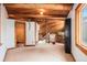 Hallway with exposed wood beams and staircase, offering a cozy and rustic aesthetic at 10419 Christopher Dr, Conifer, CO 80433