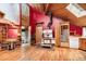 Unique kitchen showcasing a vintage stove, hardwood floors, rustic wooden beams, and an adjacent dining area at 10419 Christopher Dr, Conifer, CO 80433