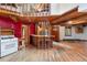 Living area featuring wood beams, and an open layout seamlessly integrating the kitchen and dining areas at 10419 Christopher Dr, Conifer, CO 80433