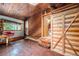 Cozy living room featuring wood paneled walls and ceilings, and unique wooden furniture at 10419 Christopher Dr, Conifer, CO 80433