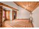 Bright living room boasts wood-beamed ceilings and hardwood floors, offering rustic charm at 10419 Christopher Dr, Conifer, CO 80433