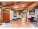 Cozy living room with beautiful wood floors, exposed beams, and natural light creating a warm and inviting atmosphere at 10419 Christopher Dr, Conifer, CO 80433