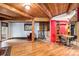 Cozy room featuring a vintage stove, hardwood floors, wooden beams, and a cozy dining nook at 10419 Christopher Dr, Conifer, CO 80433