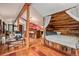 Open floor plan featuring a bed nook, kitchen, and living room with hardwood flooring at 10419 Christopher Dr, Conifer, CO 80433