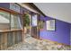 Unique room features a deck entrance, wood paneling, and sloped ceilings at 10419 Christopher Dr, Conifer, CO 80433
